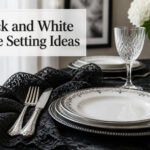 Elegant black and white table setting with layered textures and decorative elements.